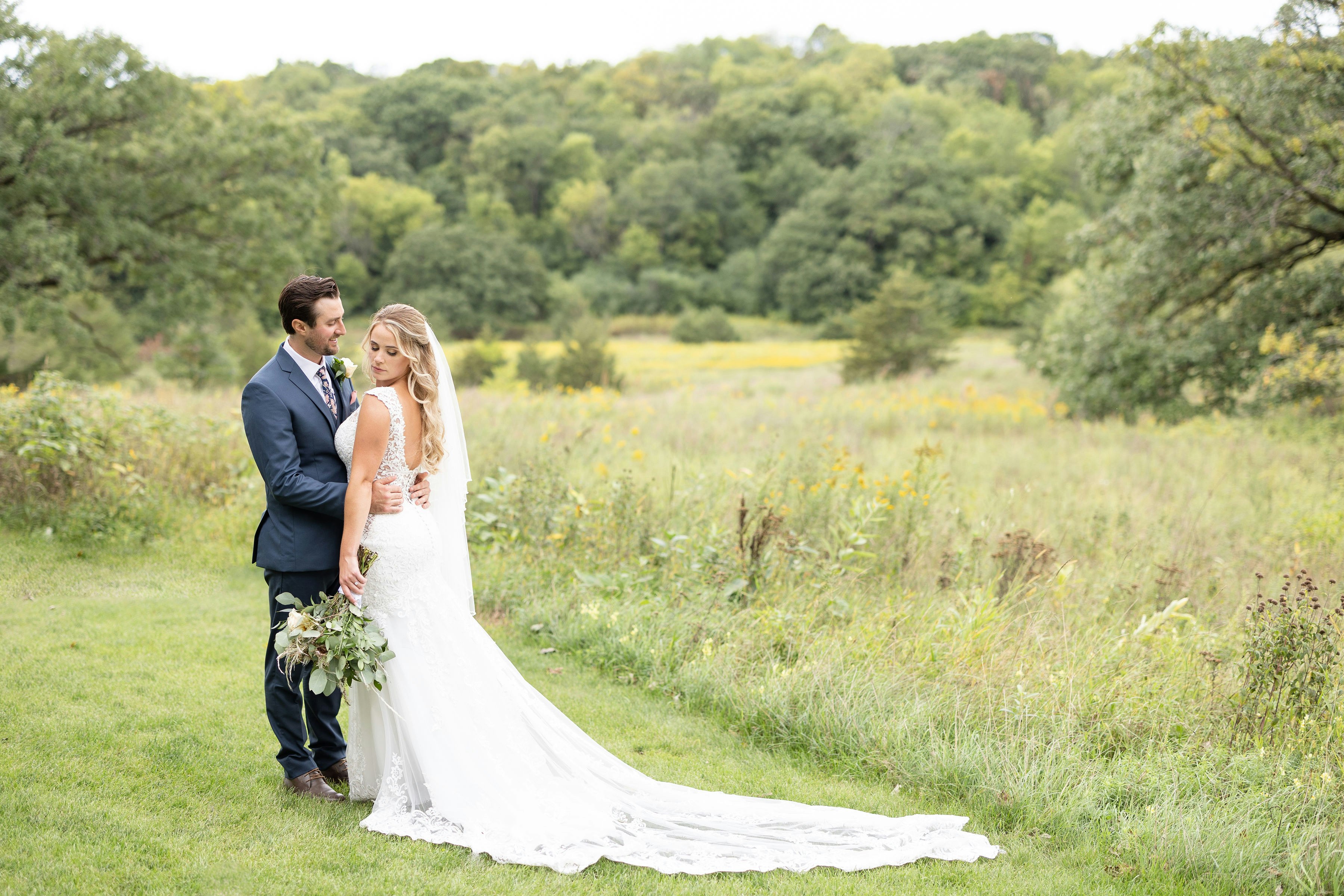 Bride with half up glam waves and her groom
