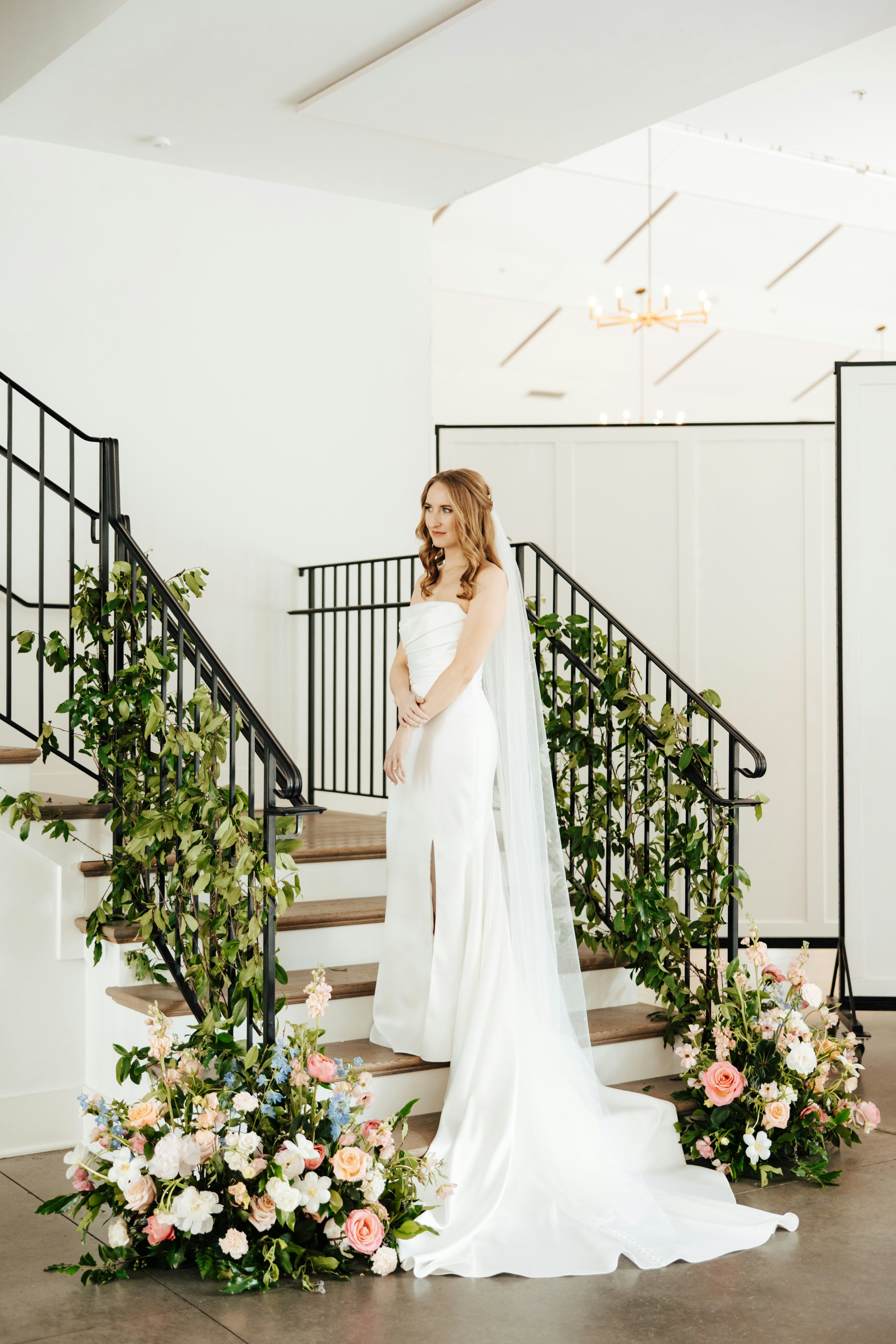 Bride posing on staircase at Hutton House