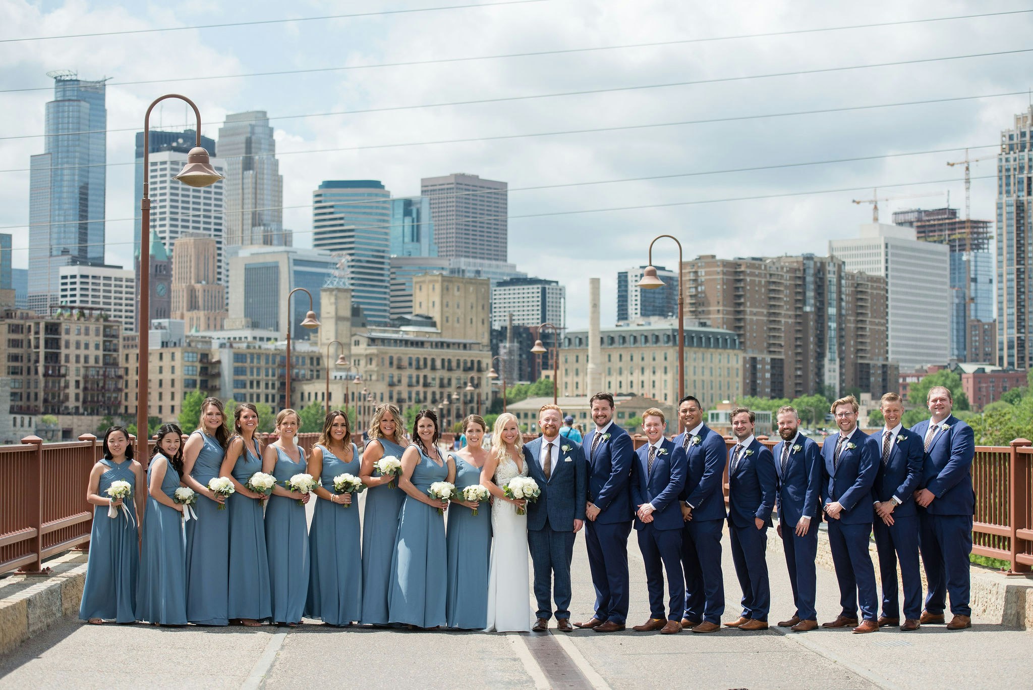 Large bridal party on Stone Arch Bridge