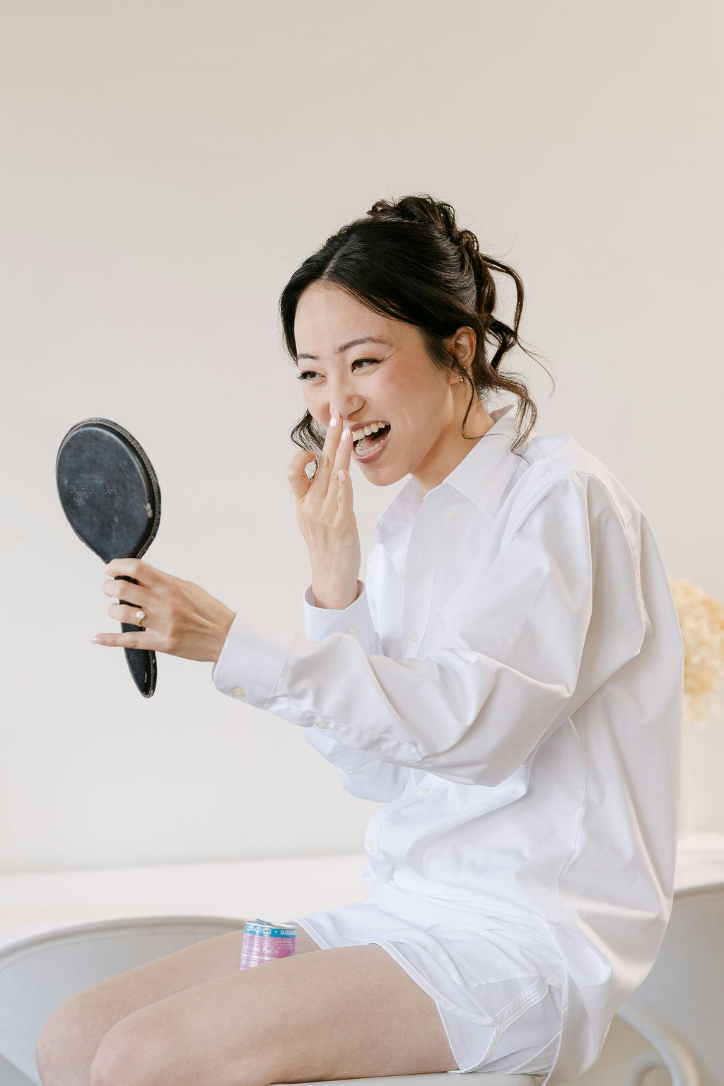 a happy brides first look at her makeup