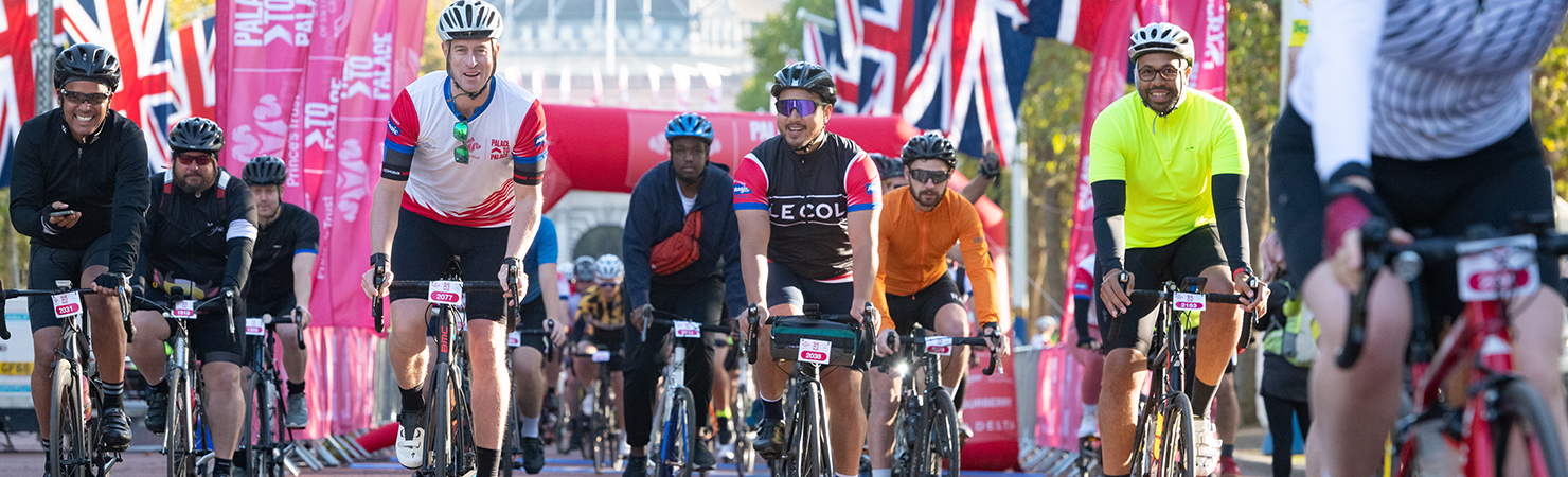 A group of cyclists coming off the start line at Palace to Palace 2022