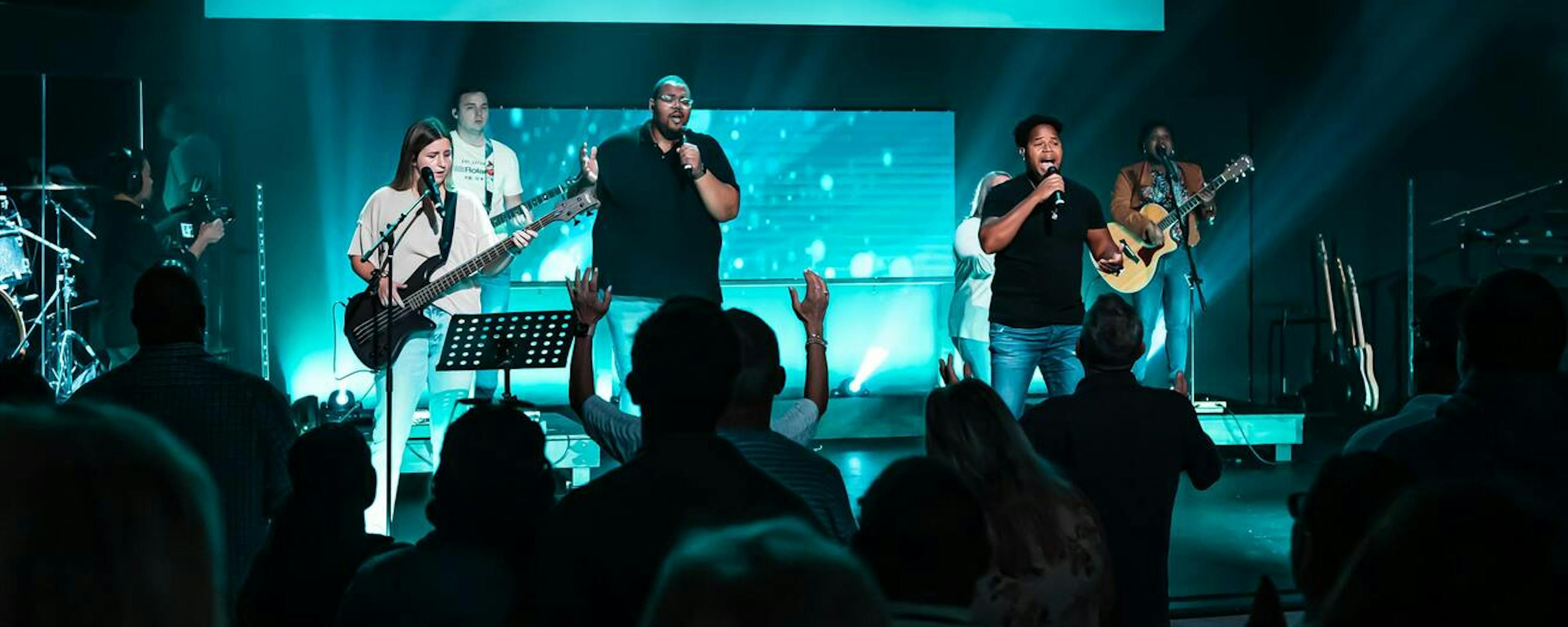 People worshipping inside the sanctuary of Kingsway Church