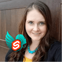 A portrait of Brittney Postma smiling, with an overlaid logo for the Svelte Sirens community.