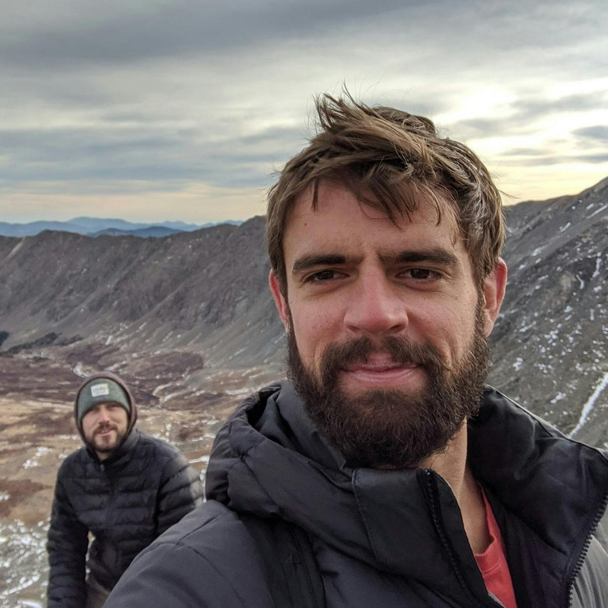 Picture of Tucker Triggs hiking on a mountainside.