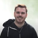 portrait of Eddy Vinck smiling and wearing a hoodie.