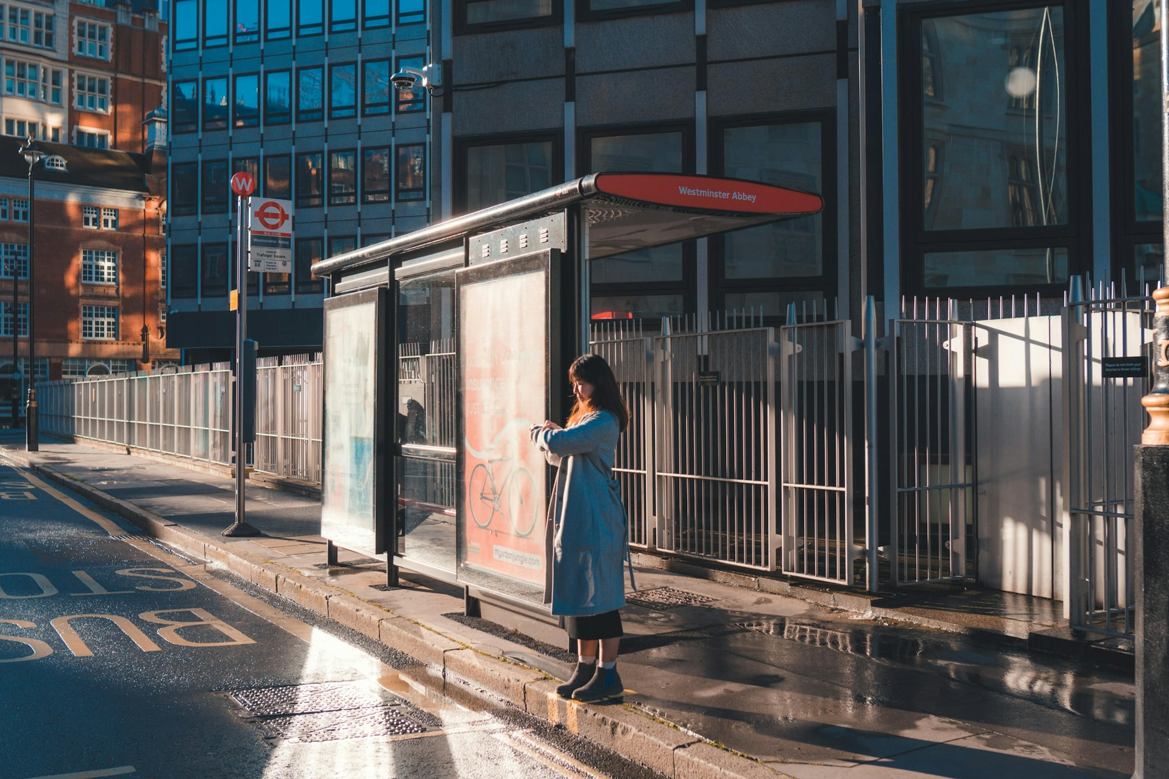 A person standing at a bus stop