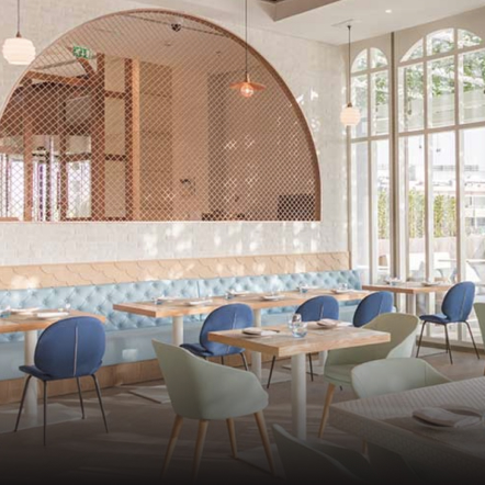 Bright indoor restaurant adorned with neatly arranged chairs and tables, creating an inviting and comfortable dining atmosphere.