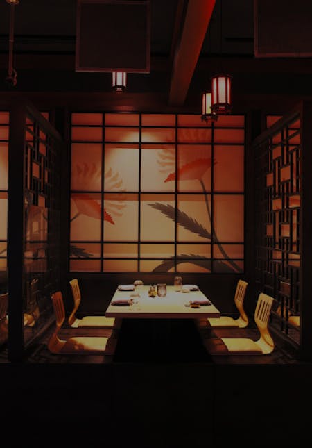 KŌYŌ Dubai, UAE - Intimate restaurant with low lighting, featuring neatly arranged tables and chairs creating a cozy ambiance. 