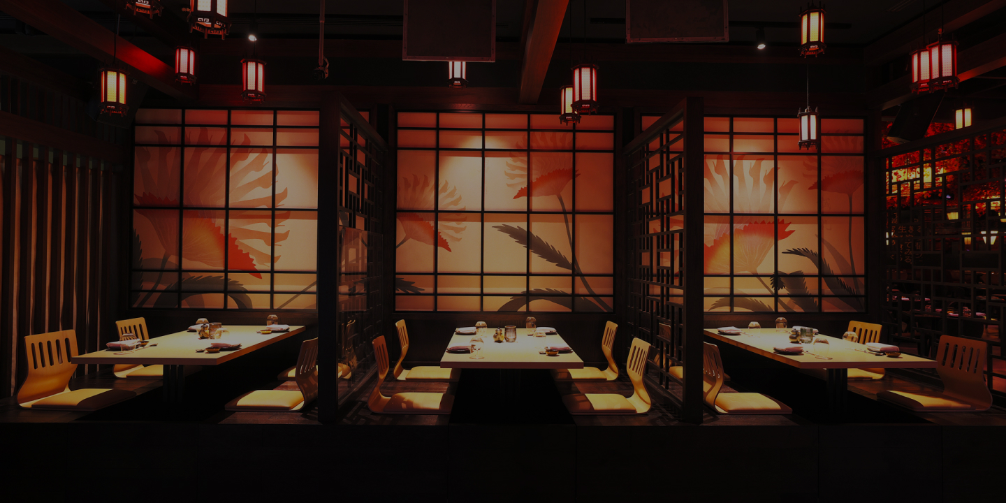 KŌYŌ Dubai, UAE - Intimate restaurant with low lighting, featuring neatly arranged tables and chairs creating a cozy ambiance. 