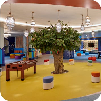 Indoor kids club with games and mini chairs.