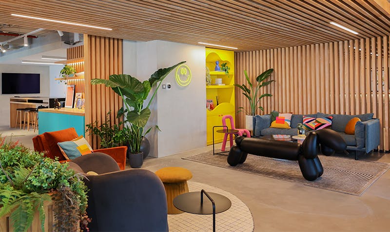 Bright and colourful office space with vibrant decor, featuring a variety of lively hues and modern furniture.