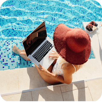 Girl sitting by the pool remote working using laptop Girl sitting by the pool remote working using laptop