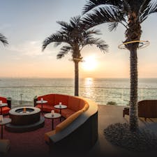 Sunset view from an outdoor terrace overlooking the ocean. 