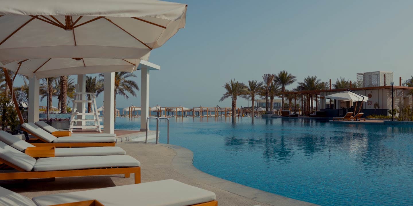 sun beds and umbrellas by the pool at InterContinental Ras Al Khaimah Resort and Spa