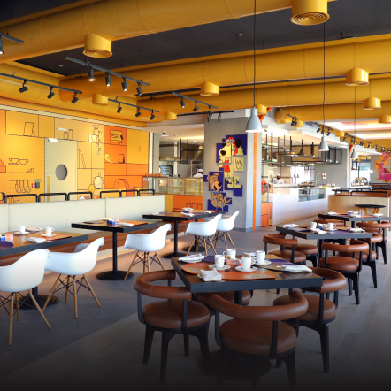 Bright indoor restaurant adorned with neatly arranged chairs and tables, creating an inviting and comfortable dining atmosphere.