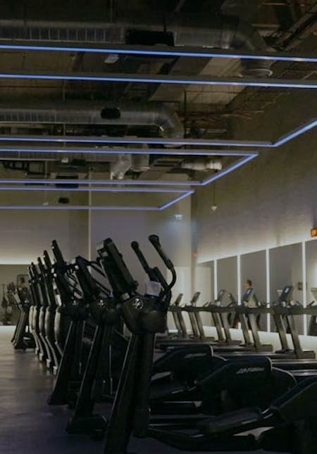 Gym cardio machines in a fitness class studio