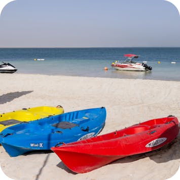 Canoe, water sports and activities on JBR beach, Dubai UAE, with views of Ain Dubai. 