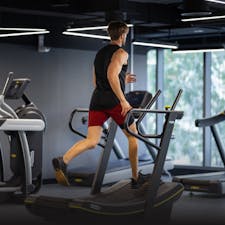 Man running on a treadmill in Qatar gym