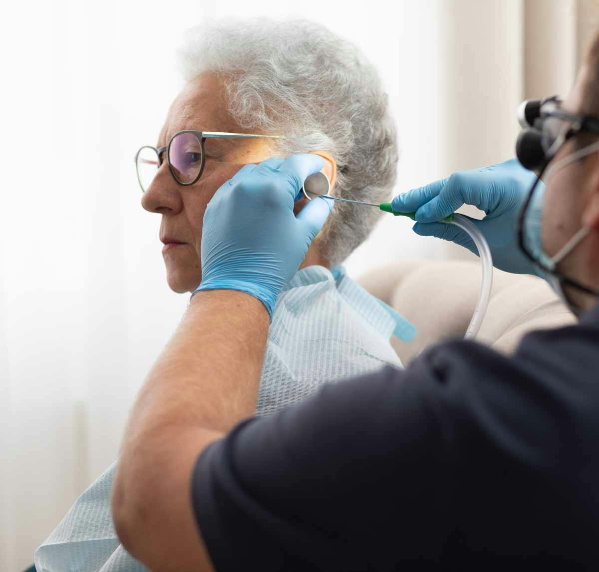 a professional earwax specialist doing microsuction on a patient