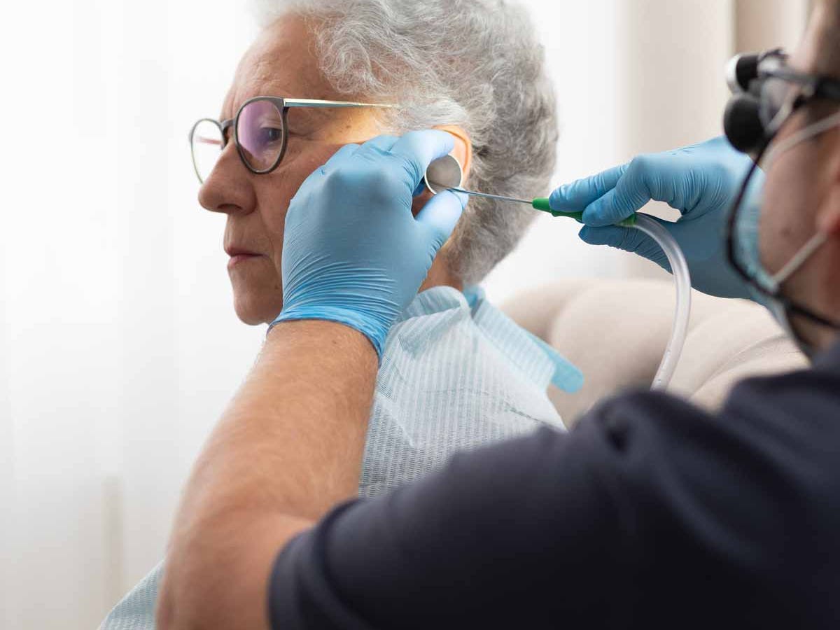 a professional earwax specialist doing microsuction on a patient