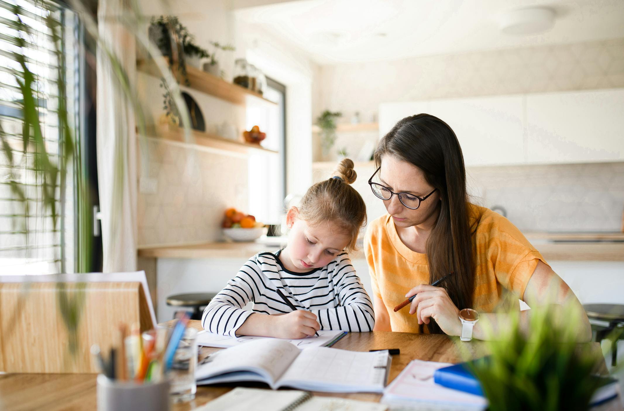 parent helping her child with homework