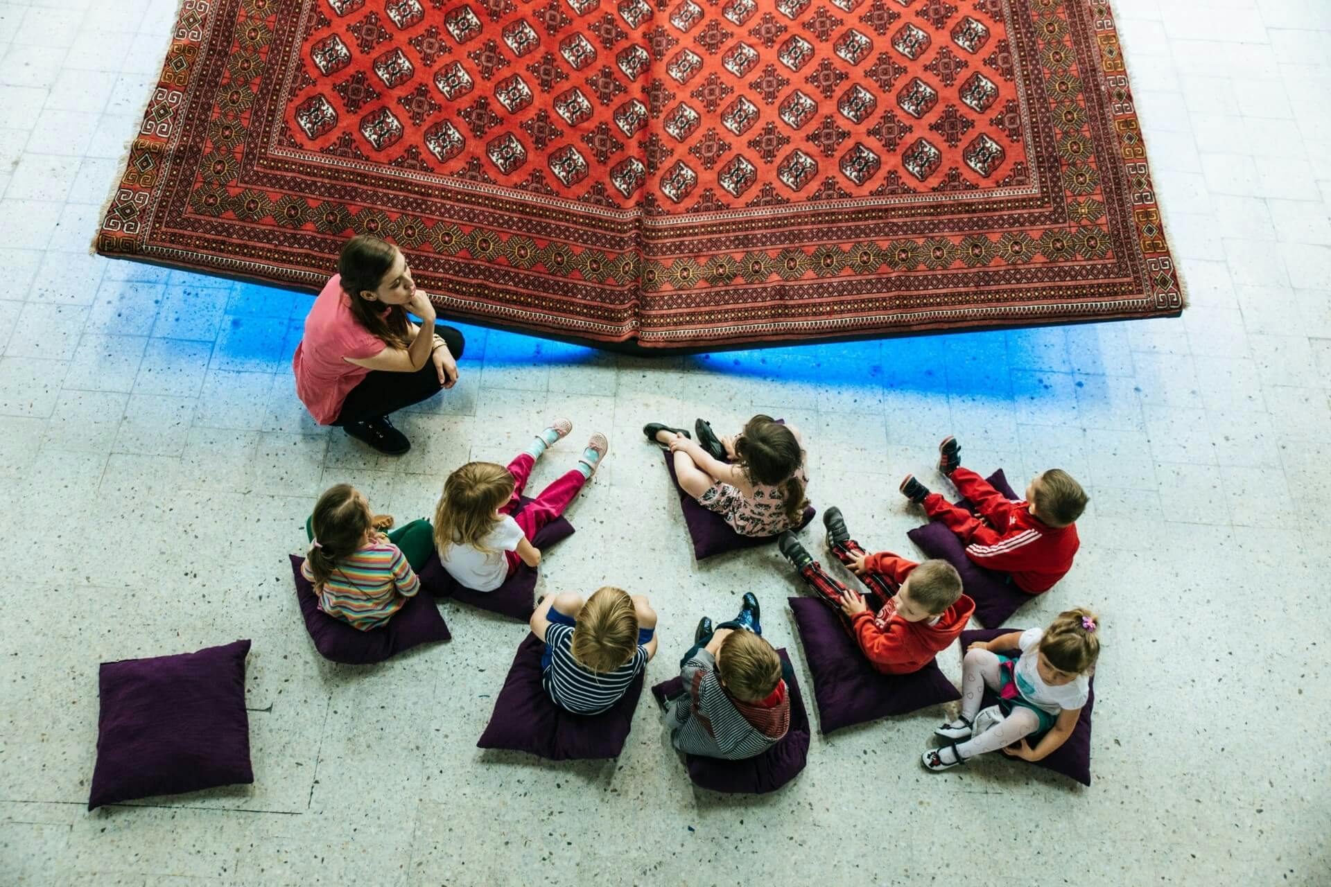 A teacher and her students at a museum.