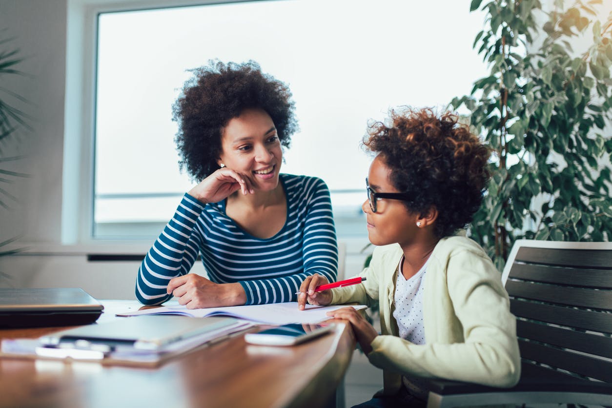 A mother and her child going over homework together.