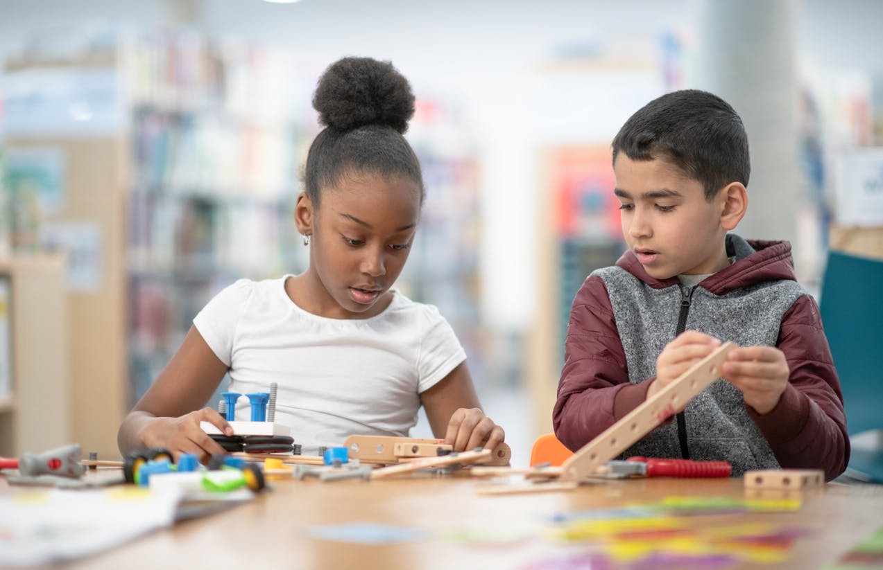 Two elementary kids engaged in student-centered learning at a maker space.