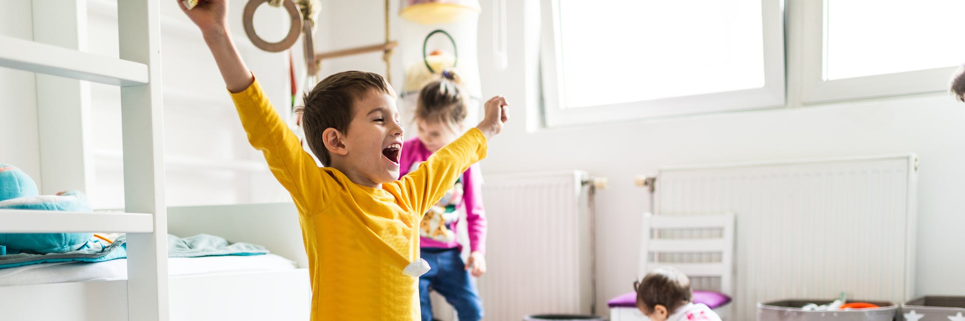 Three kids having fun indoors as they play.