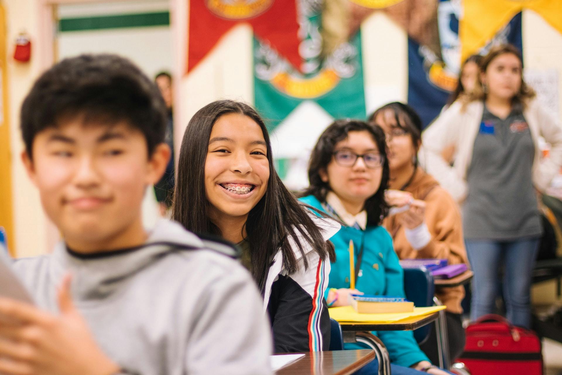 Smiling students sit in a math classroom during fun math activities.