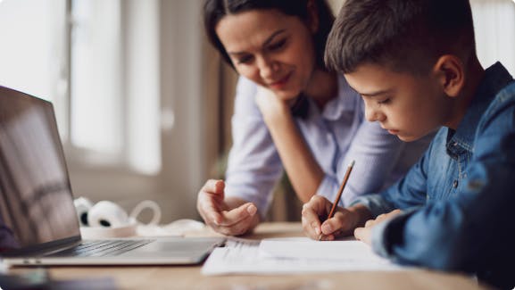 Parent and Child going homework with Laptop