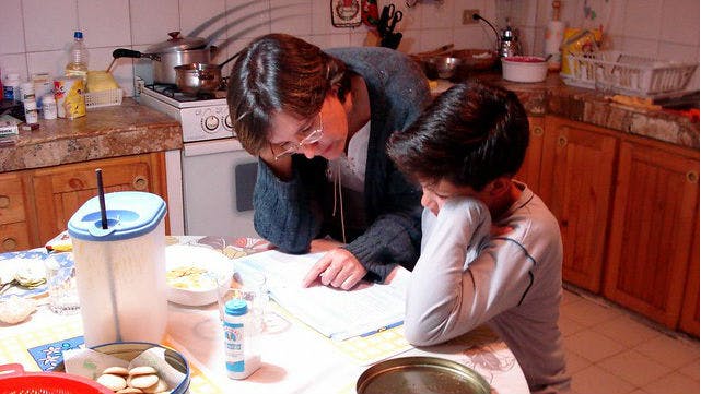 A child is getting math help with a parent.