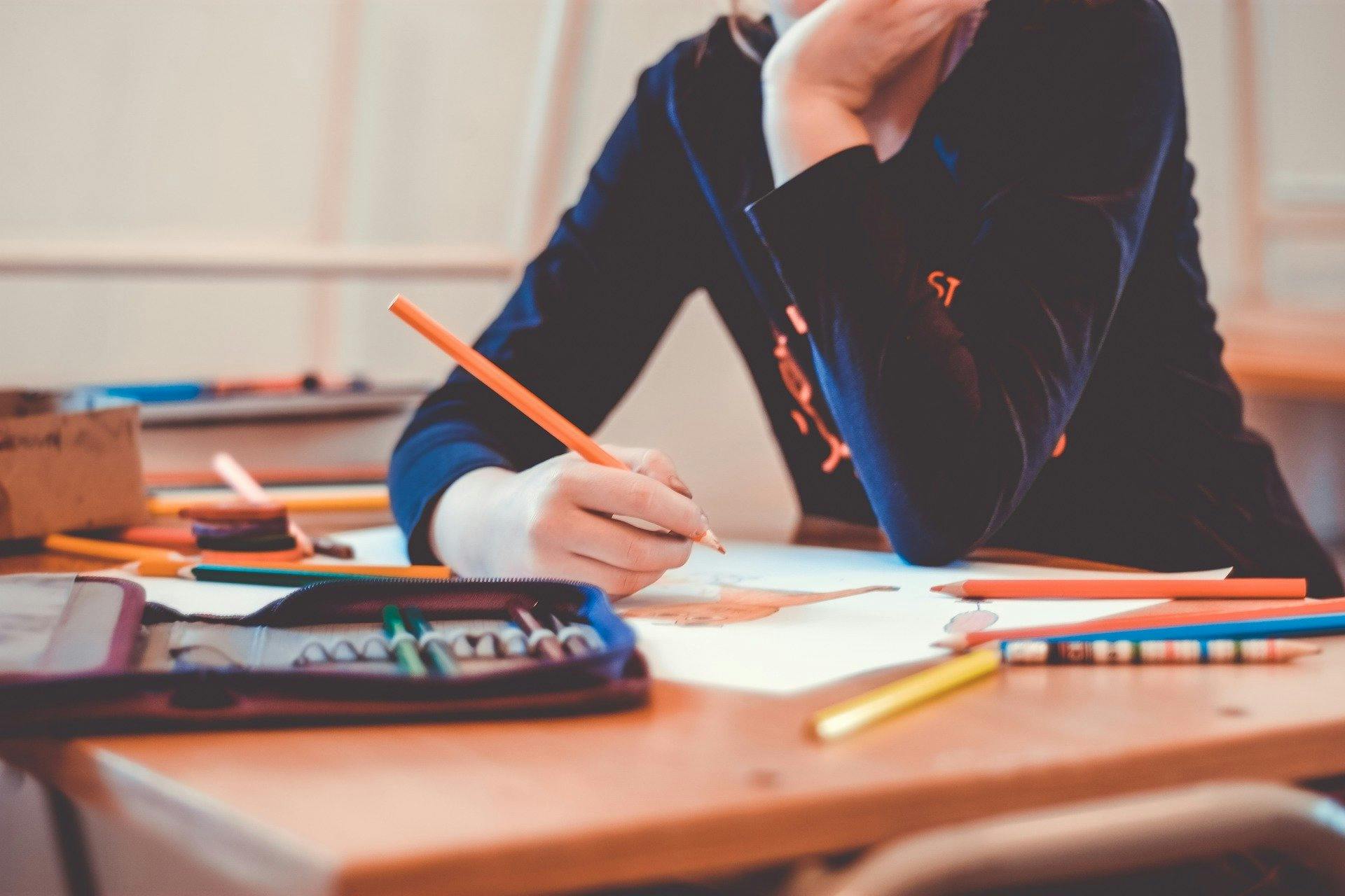 A student draws in her notes as she studies.