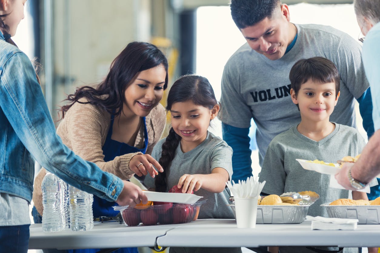 Family volunteering at a soup kitchen together.