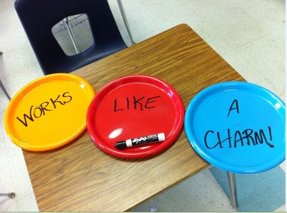 Example of a great teacher hack that uses plastic plates as personal reusable dry erase boards.