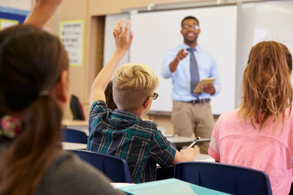 A teacher selecting a student to answer a question in class.