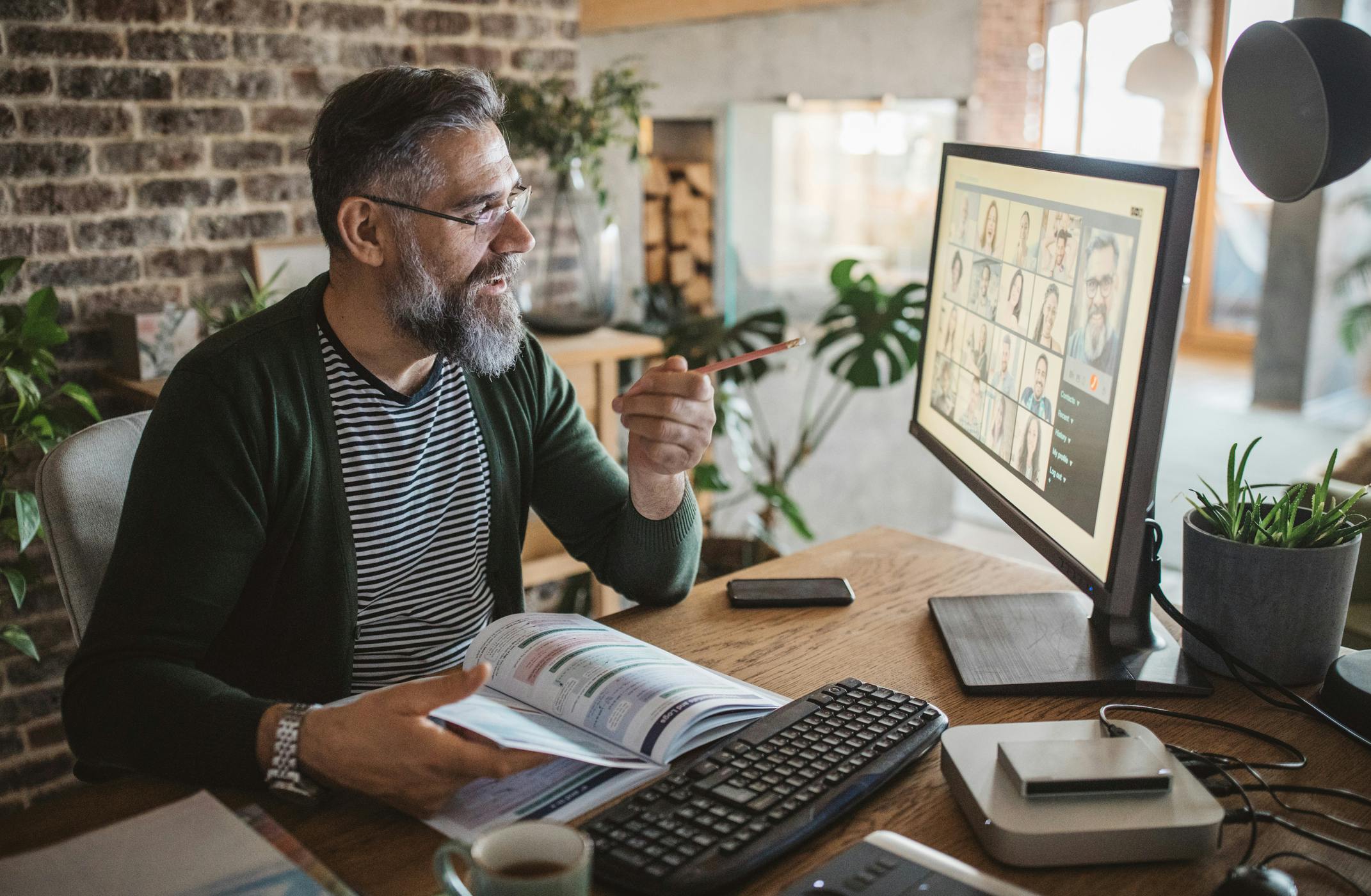 Teacher working at home on his computer.