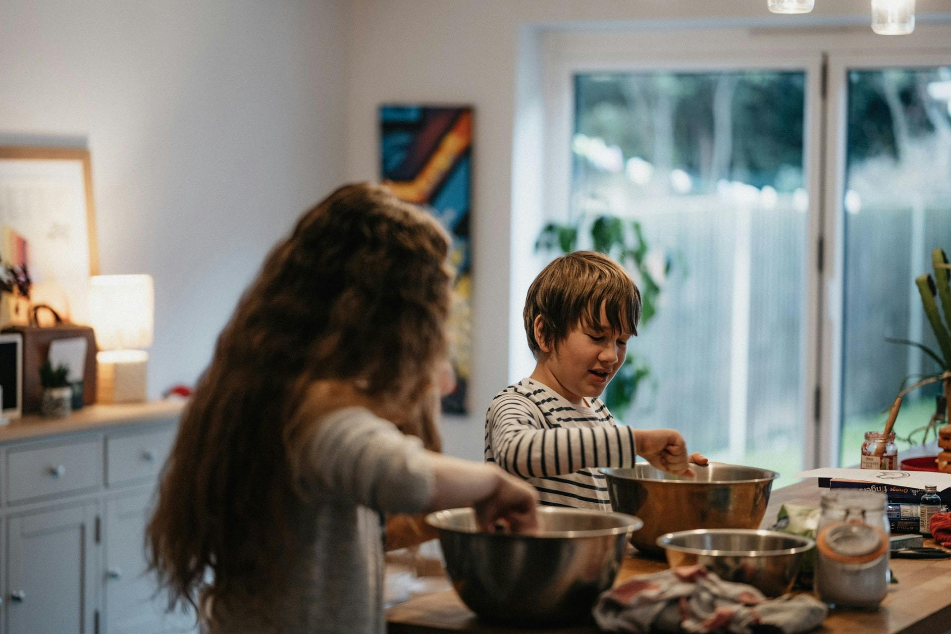 Two children bake in a kitchen and make dirt cup treats in honor of Earth Day