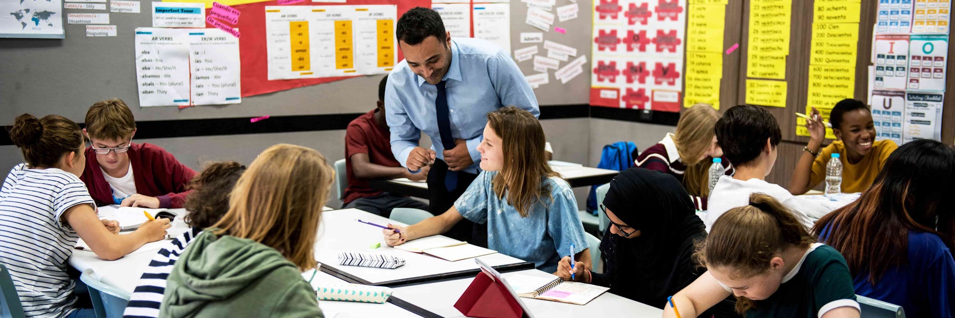 Teacher supporting a large class of students.