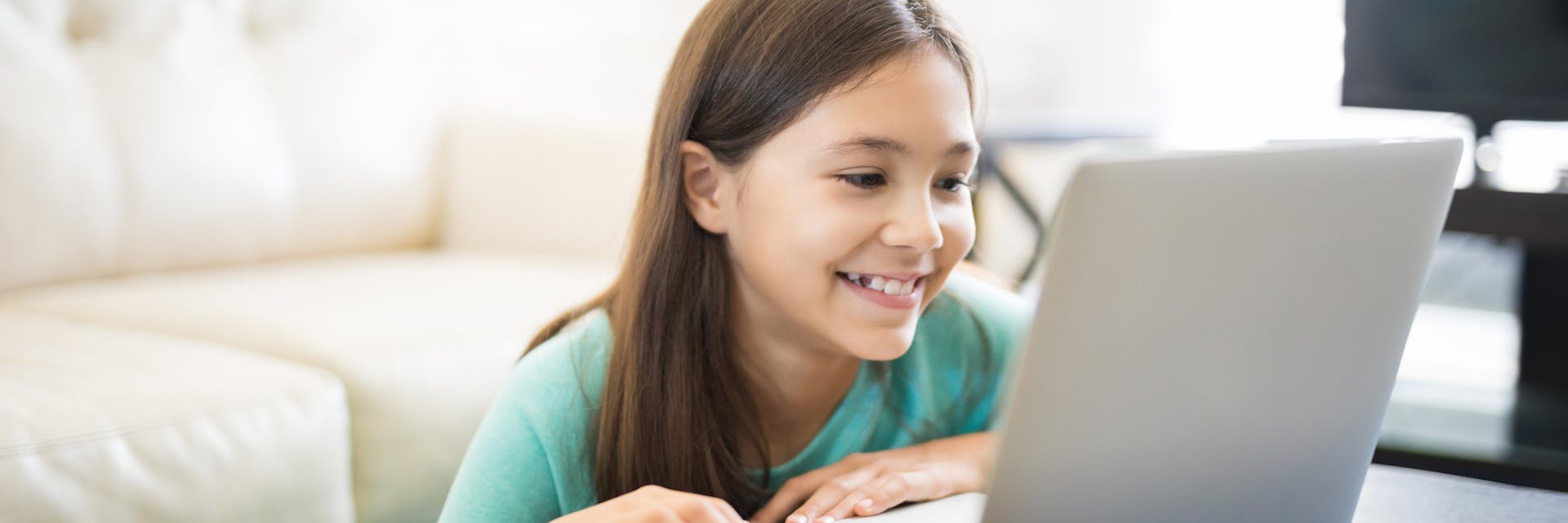 Girl on laptop playing some of the best browser games.