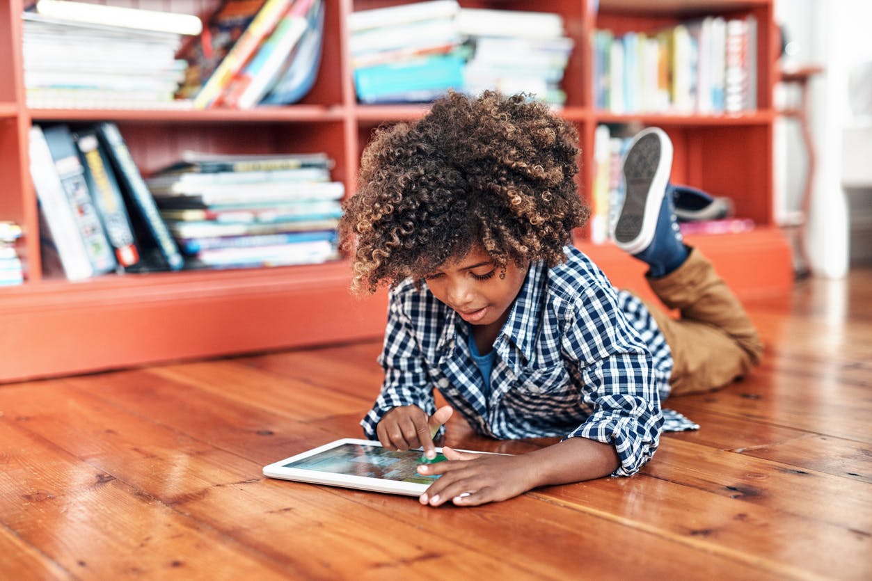 Child at home, enjoying his Prodigy Membership on his tablet.