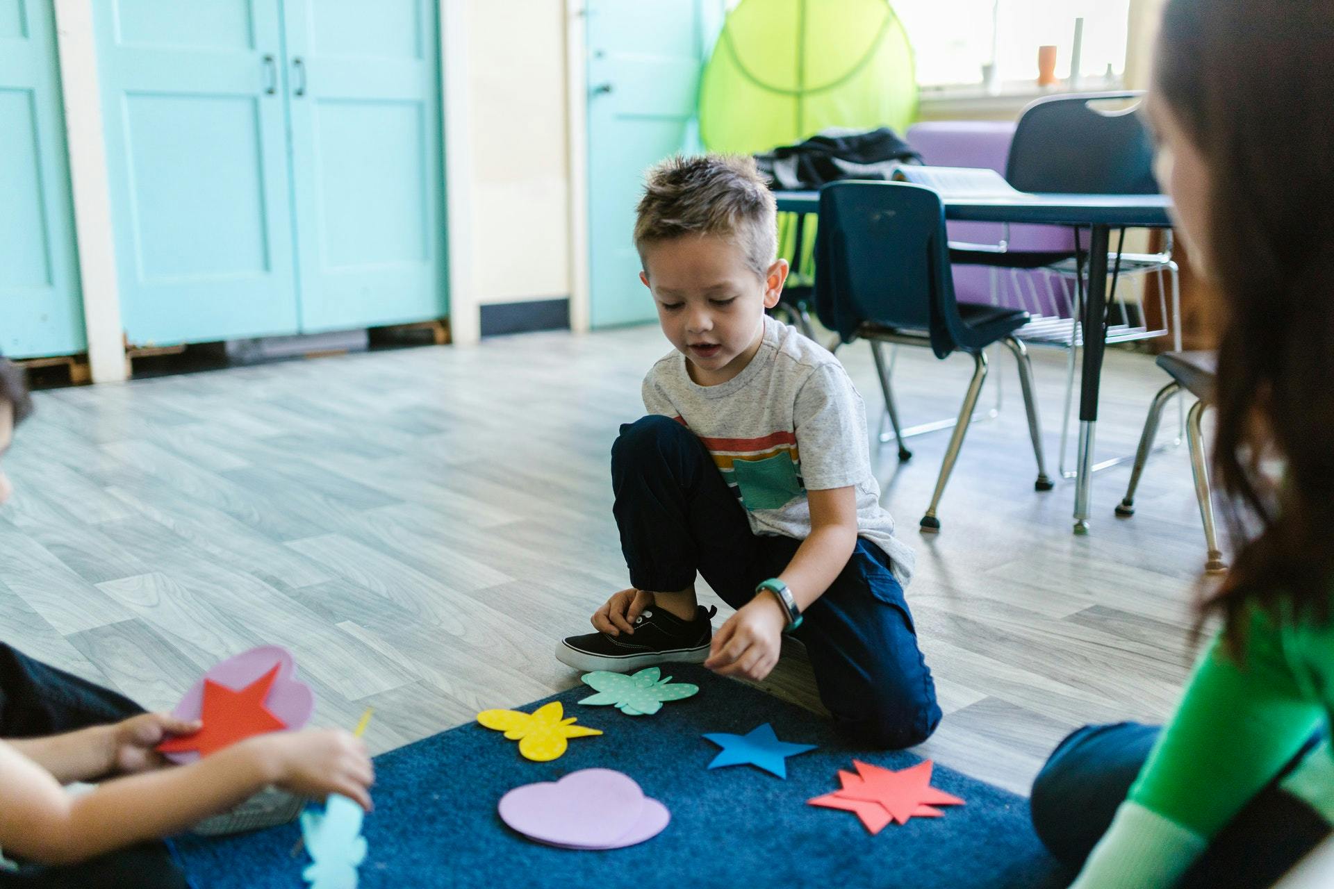 Young boy works on addition activities with a felt mat in his classroom. 