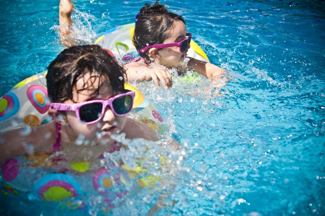 Children swimming in a pool during playdate activities