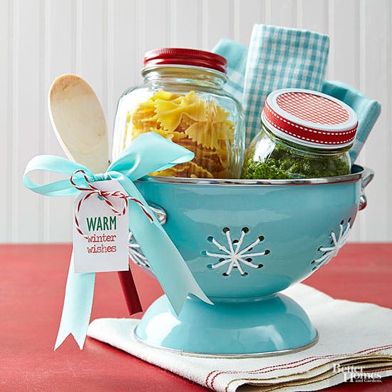 DIY meal kit in blue bowl with a wooden spoon and ingredients inside.