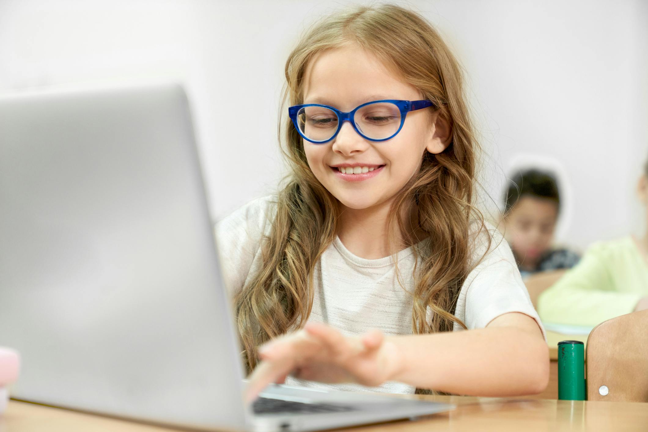 Student typing on a laptop in class