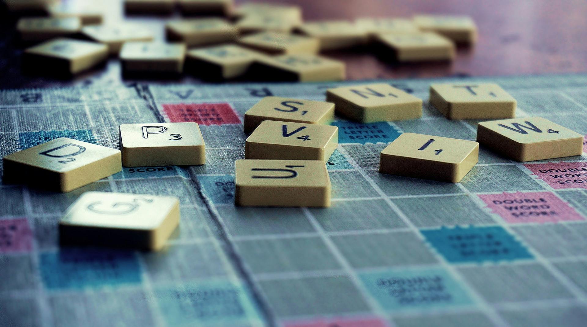 Picture of scrabble board with tiles on it.