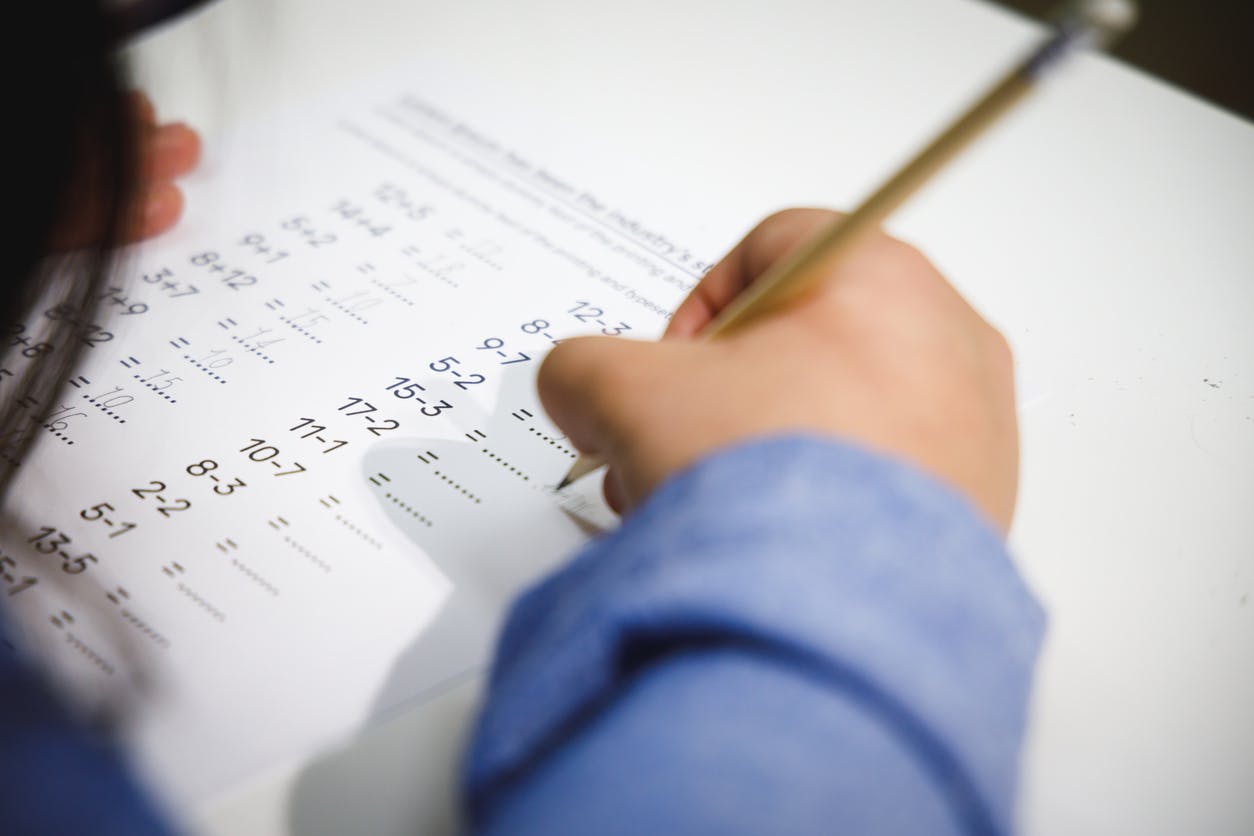 Child working on a second-grade math worksheet.