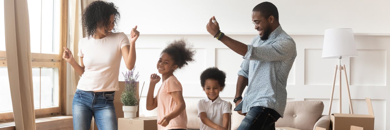 A family of four dancing in their living room for a quick and easy brain break for kids.