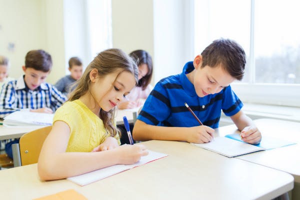 learning activities mathematics A classroom of young students writing.