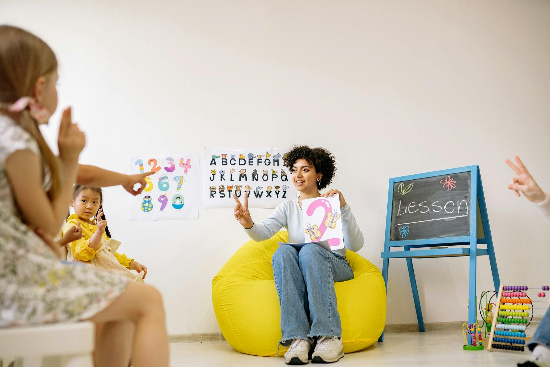 A teacher practices numbers with her classroom.